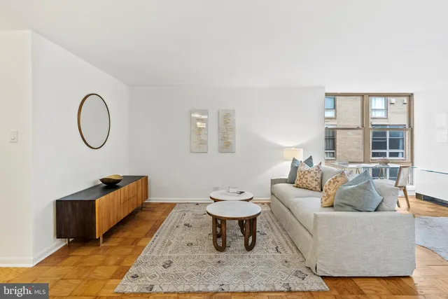 a living room with furniture a rug and a table