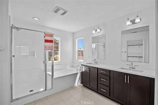 a spacious bathroom with a shower sink and mirror