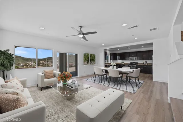 a living room with furniture and view of kitchen