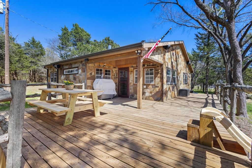 236 Homesite Road Pottsboro, TX 75076 - Photo 17 of 40 a view of a roof deck with table and chairs a barbeque with wooden floor and fence