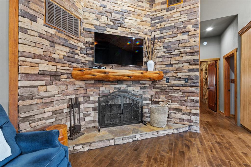 236 Homesite Road Pottsboro, TX 75076 - Photo 20 of 40 a living room with a fireplace and a flat screen tv