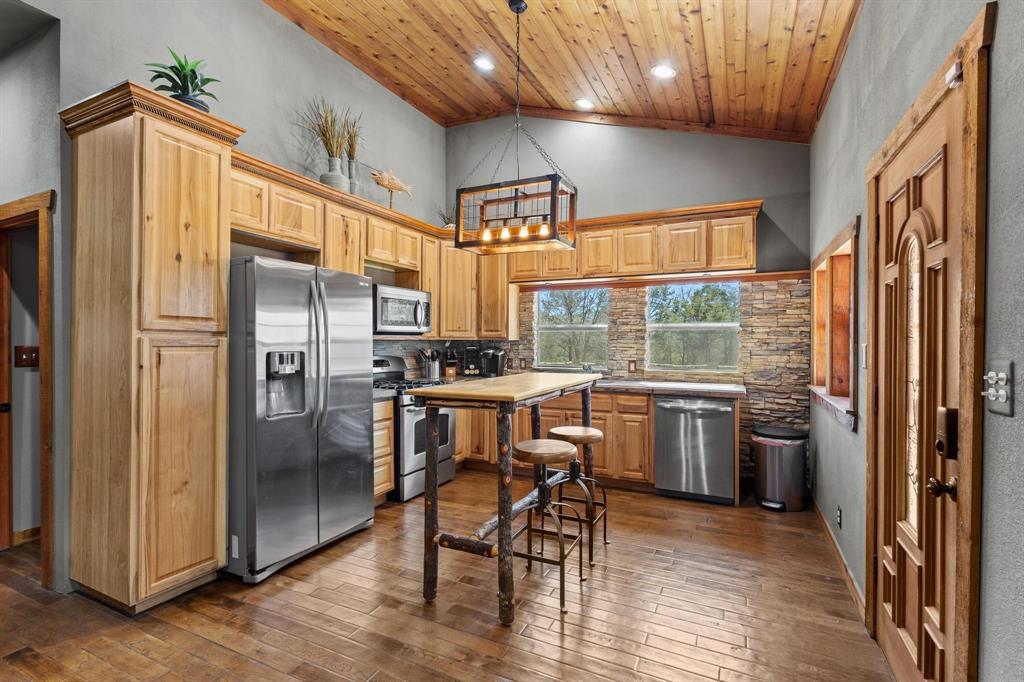 236 Homesite Road Pottsboro, TX 75076 - Photo 21 of 40 a kitchen with stainless steel appliances granite countertop a refrigerator a sink a stove and island