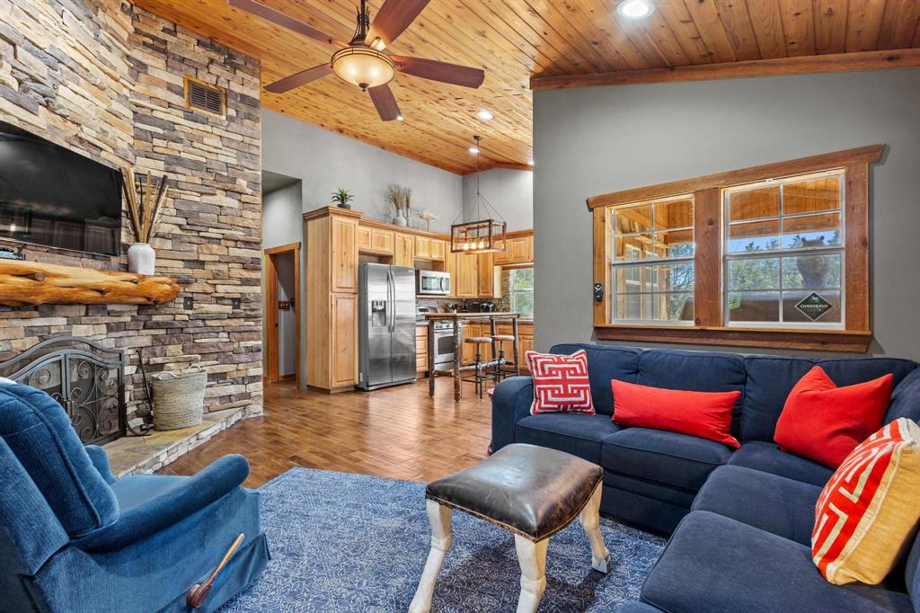 236 Homesite Road Pottsboro, TX 75076 - Photo 27 of 40 a living room with furniture a flat screen tv and kitchen view