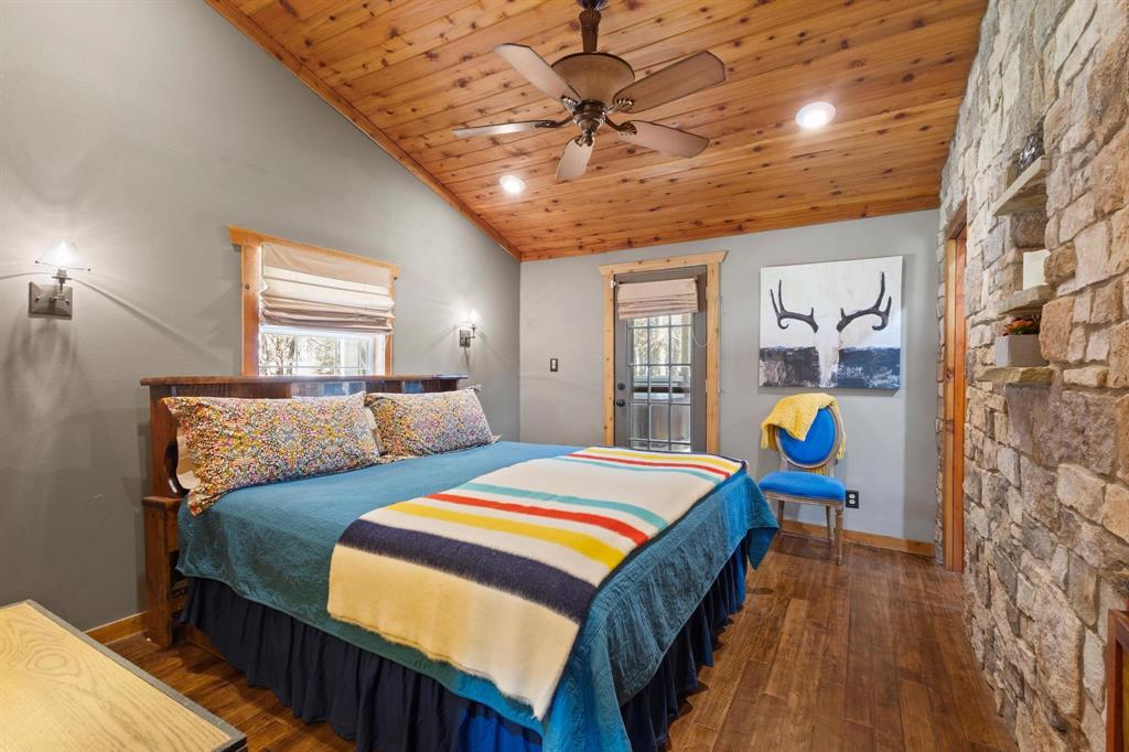 236 Homesite Road Pottsboro, TX 75076 - Photo 36 of 40 a bed room with two bed and a chandelier