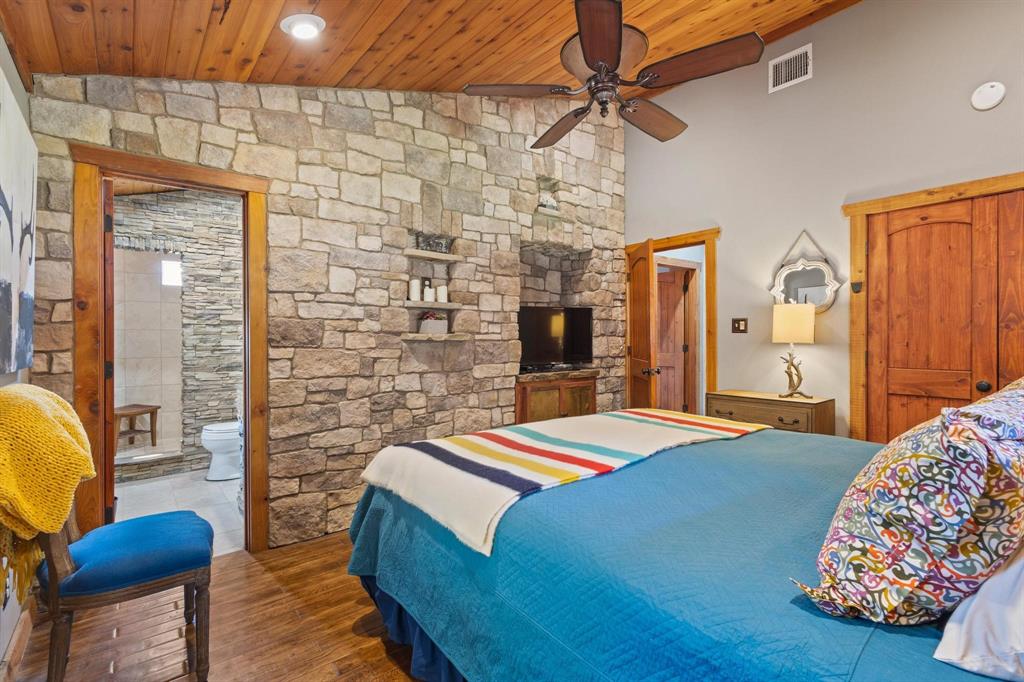 236 Homesite Road Pottsboro, TX 75076 - Photo 37 of 40 a bedroom with a bed and wooden floor