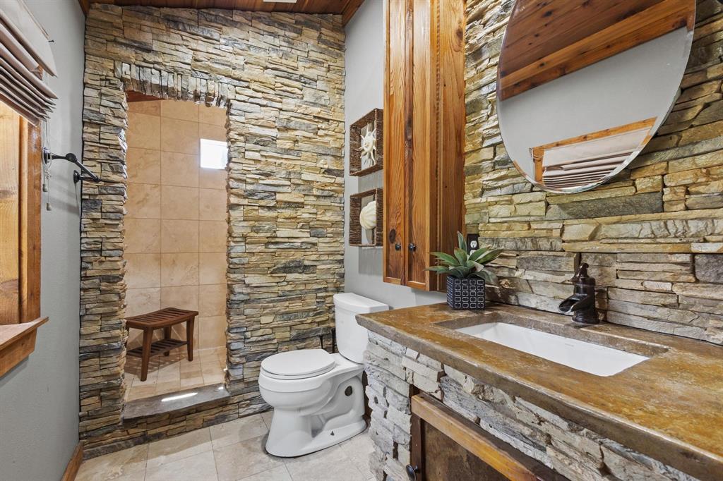 236 Homesite Road Pottsboro, TX 75076 - Photo 38 of 40 a bathroom with a sink a toilet and shower