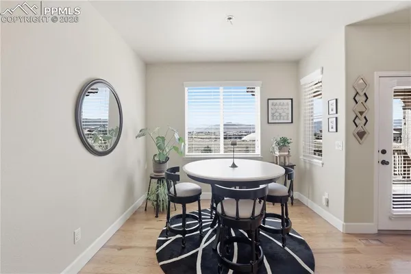 a view of a dining room with furniture and window