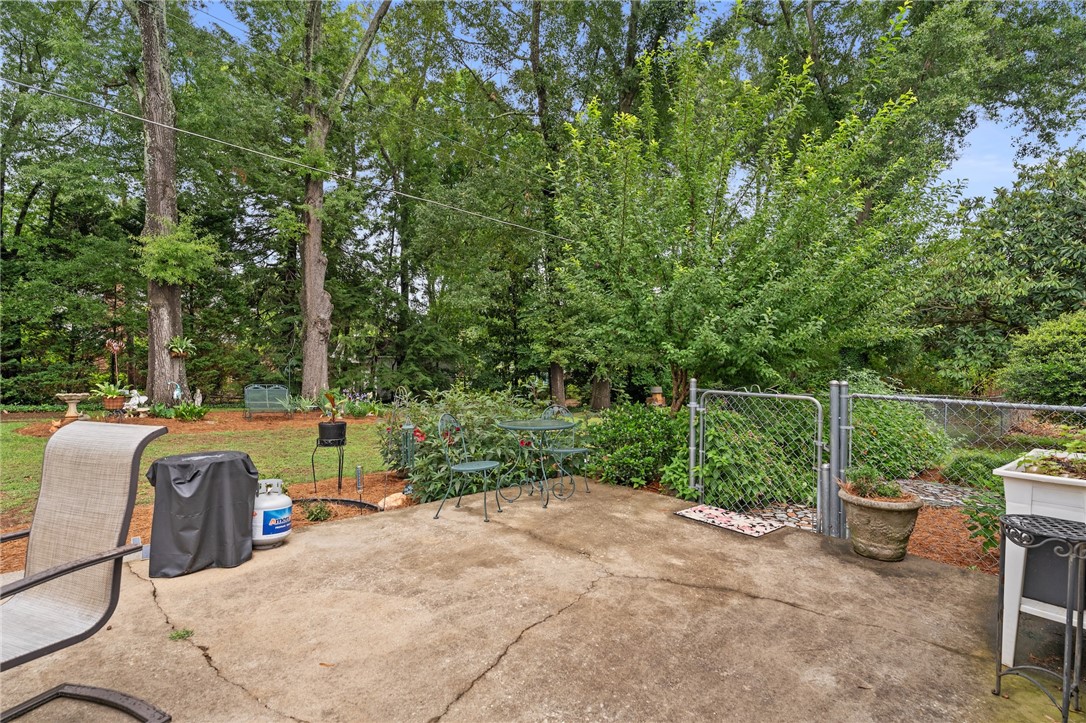 1105 Greenacres Anderson, SC 29621 - Photo 39 of 46 A private, verdant yard with mature trees and a tranquil concrete patio beckons for outdoor relaxation.