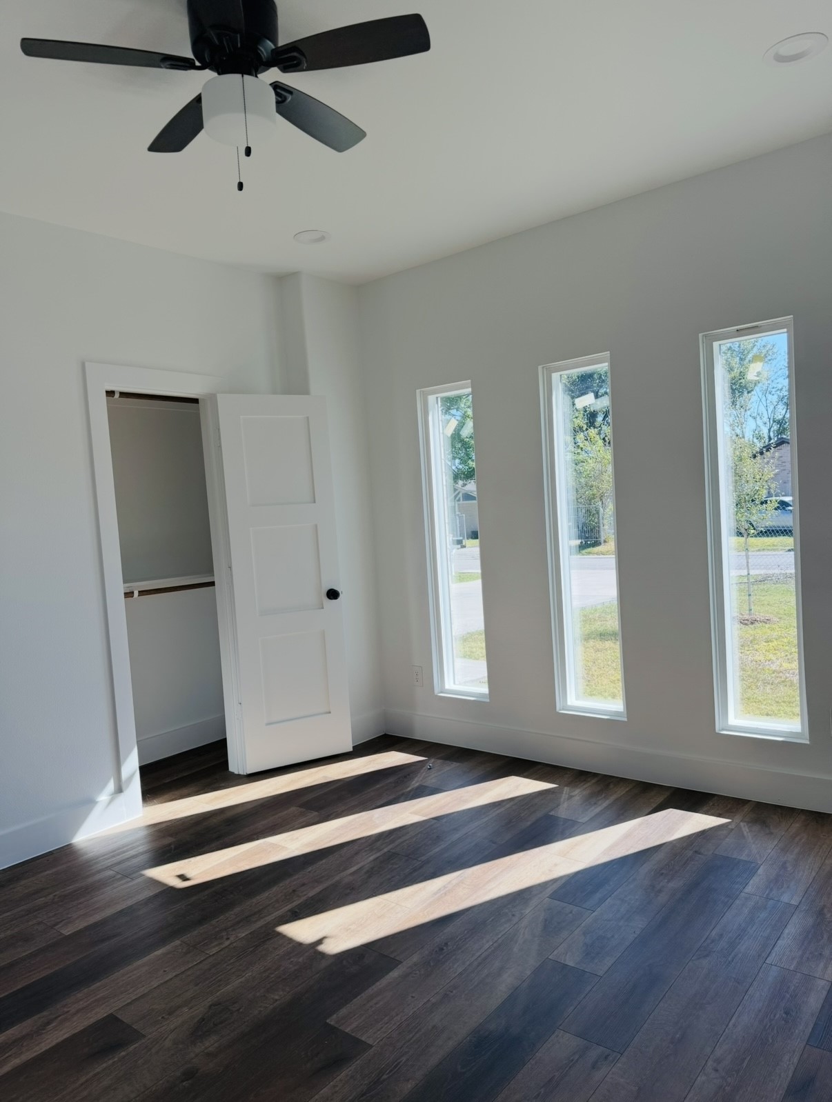 8437 Winthrop Lane Houston, TX 77075 - Photo 8 of 22 a view of an empty room with a window and wooden floor