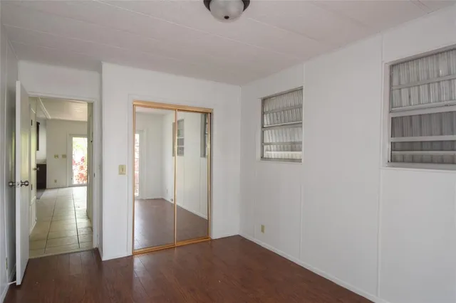 a view of a yard with plants and trees