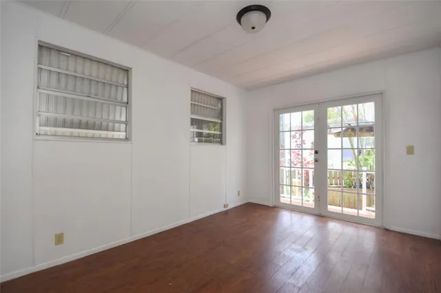 a backyard of a house with barbeque oven table and chairs