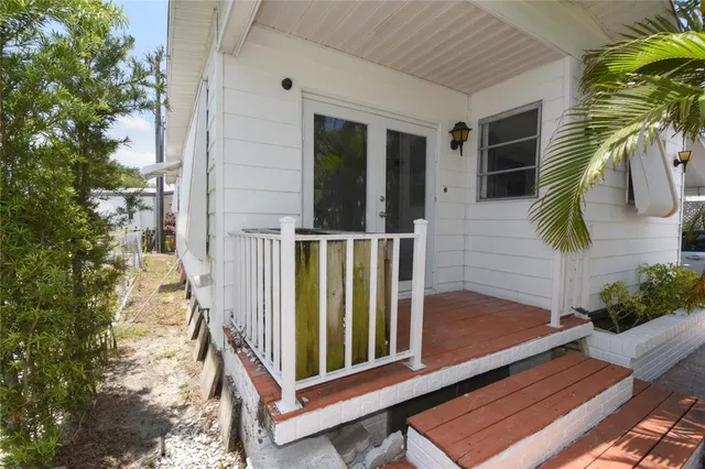 a kitchen with stainless steel appliances granite countertop a refrigerator a sink dishwasher a stove top oven a sink and dishwasher with wooden floor
