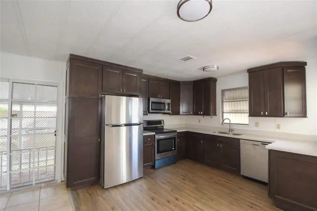 a kitchen with a sink cabinets and window