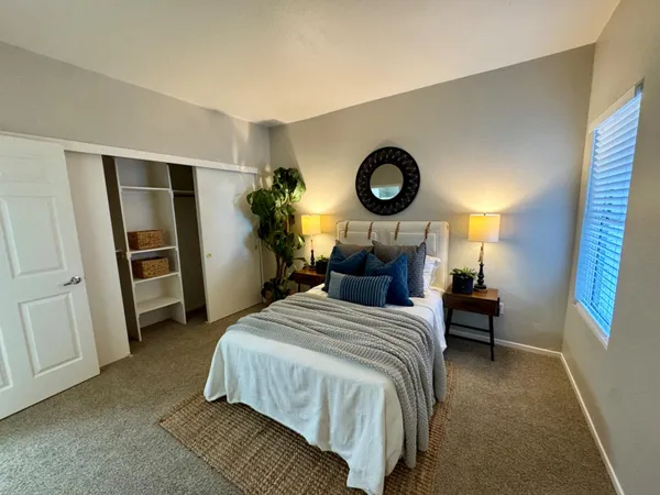 a bedroom with a bed and a window