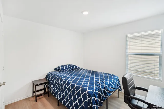 a bedroom with a bed and a window