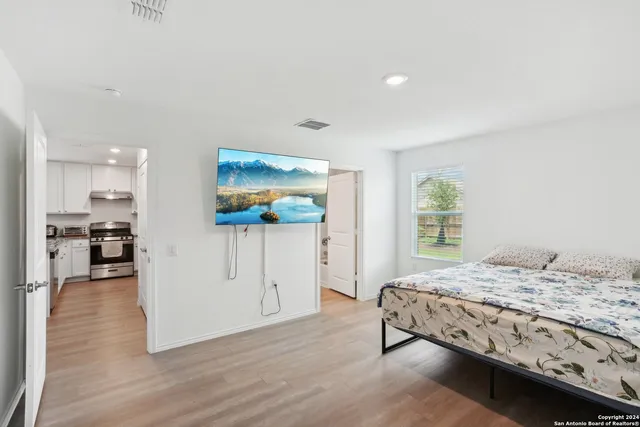 a bedroom with a bed and a flat screen tv