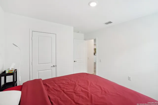 a bedroom with a bed and a closet