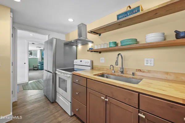 a kitchen with a sink cabinets and wooden floor