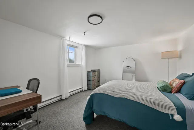 a bedroom with a bed and a table