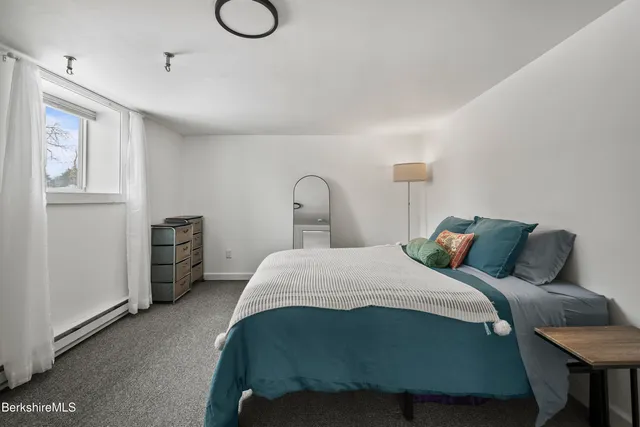 a bedroom with a bed and cabinets