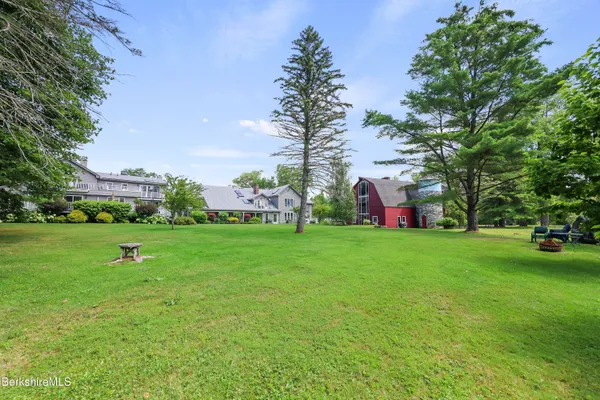 a view of yard with swimming pool and green space