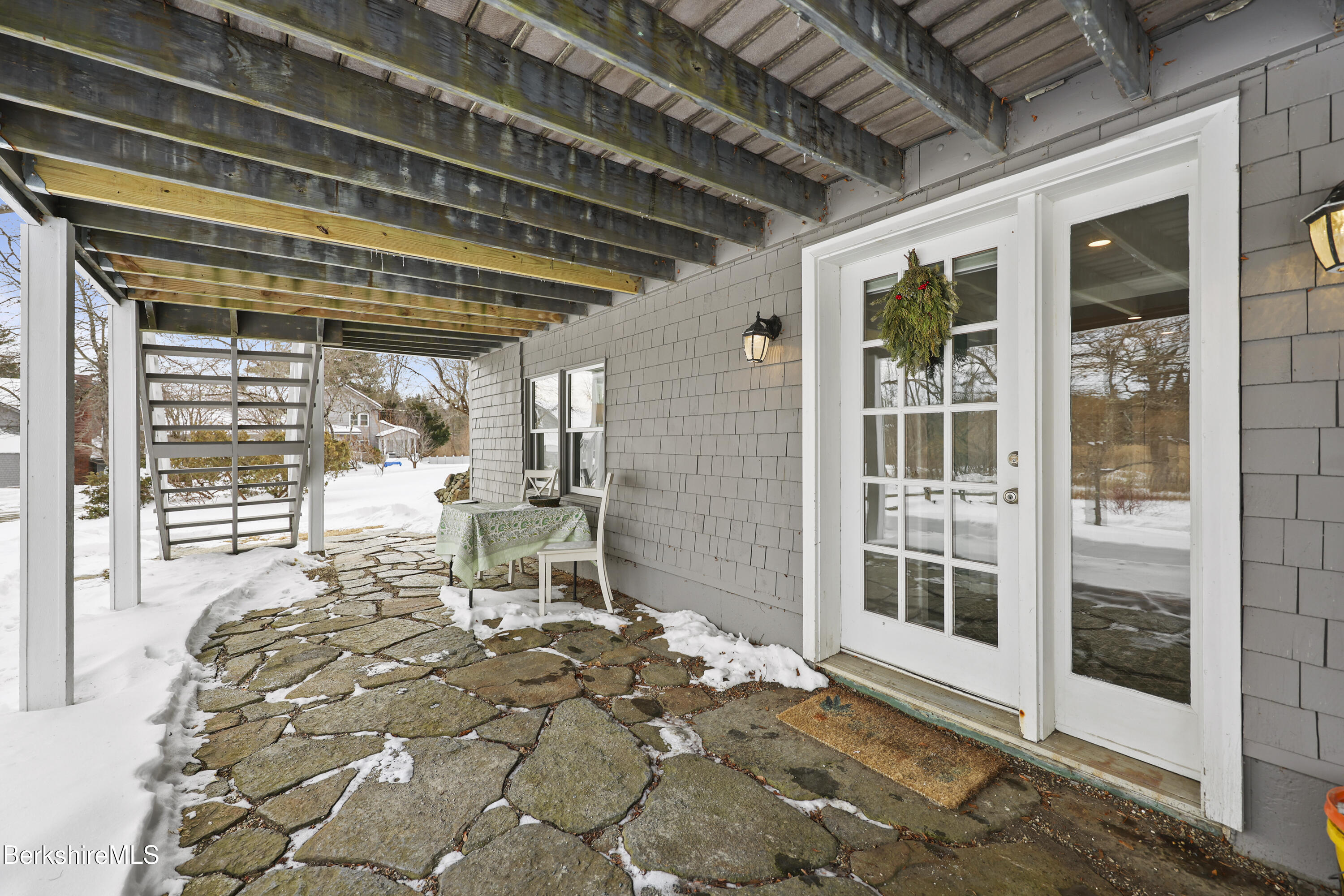 2 Wallace Road, Unit DHB Stockbridge, MA 01262 - Photo 36 of 36 a view of a porch with a table and chairs and floor to ceiling window
