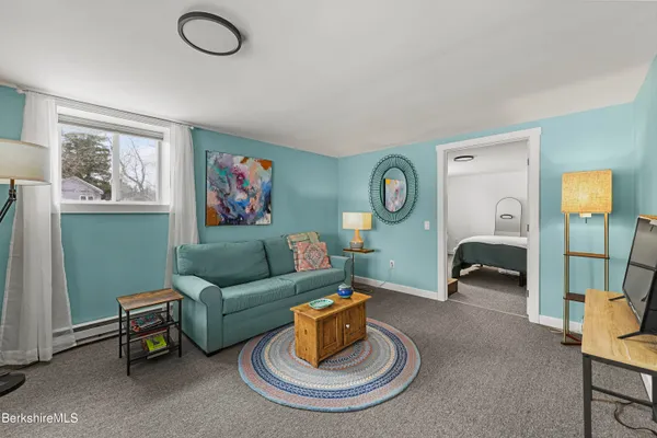 a living room with furniture and a mirror