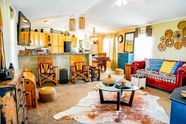 a living room with lots of chairs and a table