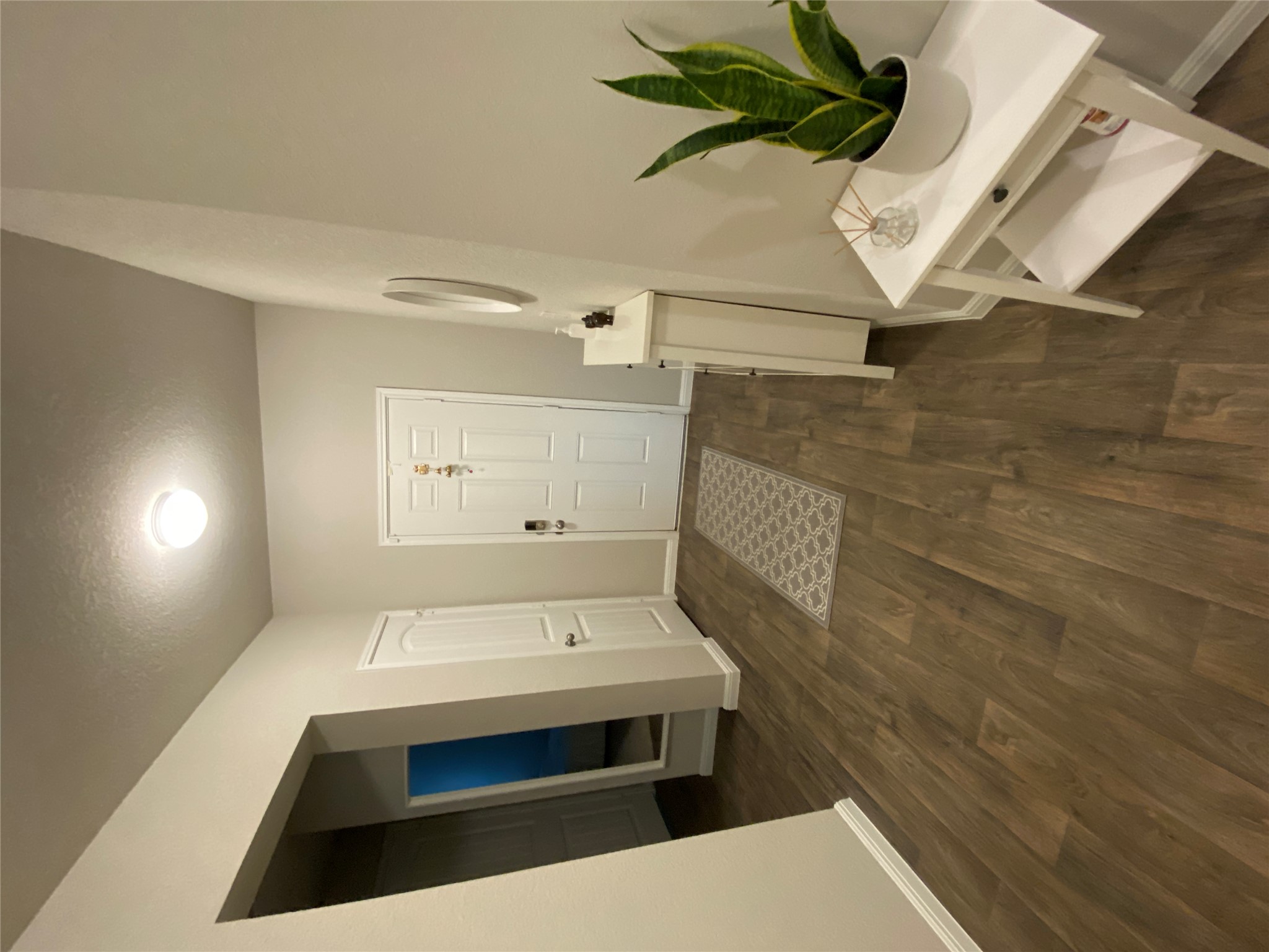 10916 Defender Trail Austin, TX 78754 - Photo 1 of 12 Foyer featuring dark wood-style flooring and a textured ceiling