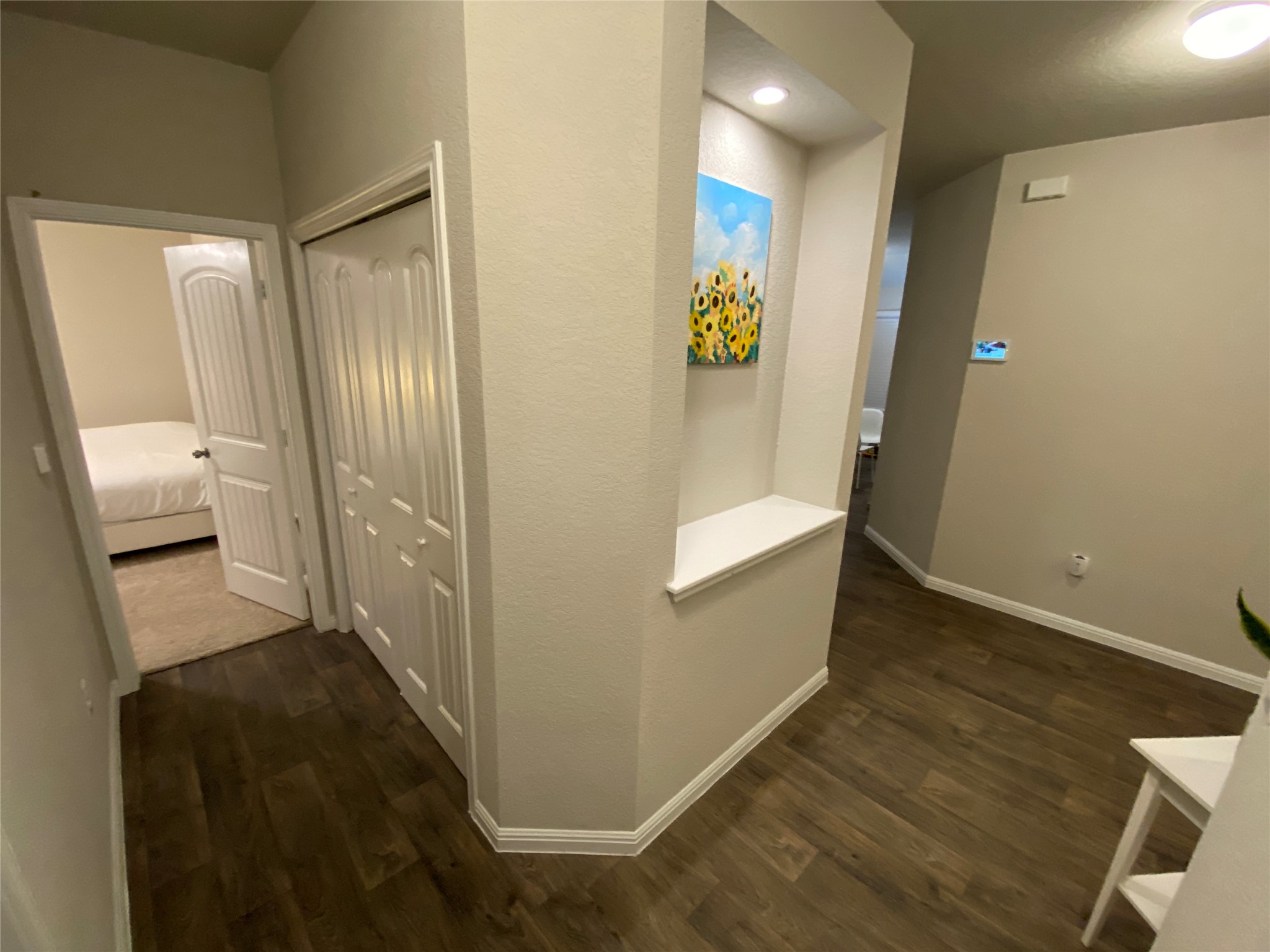 10916 Defender Trail Austin, TX 78754 - Photo 11 of 12 Hallway featuring dark wood-style flooring and a textured wall