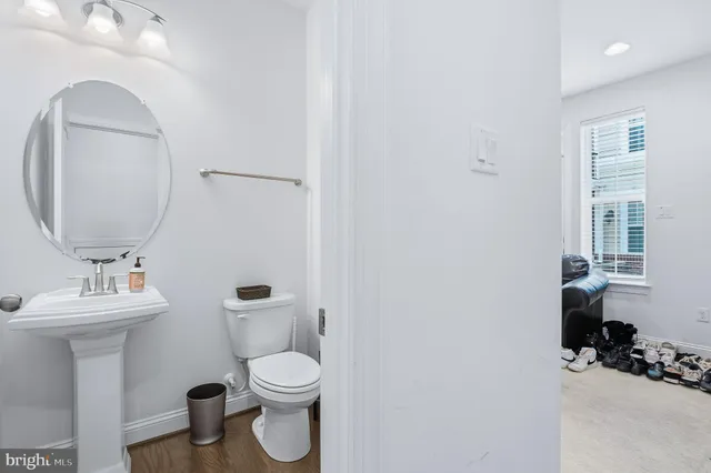 a bathroom with a toilet sink and mirror