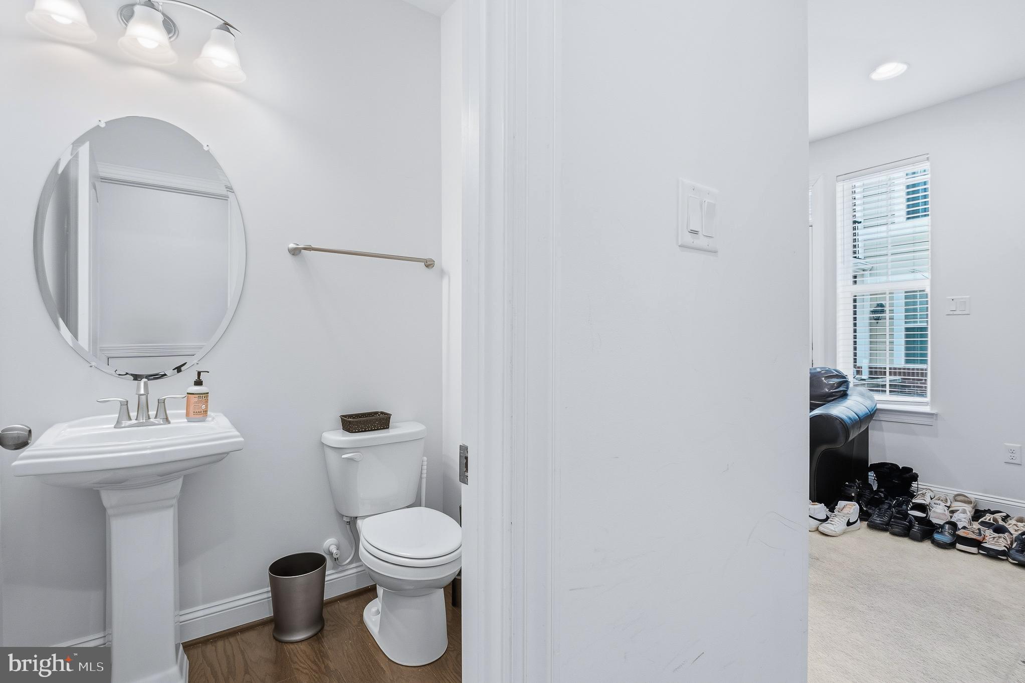 803 Francis Harris Place Annapolis, MD 21401 - Photo 11 of 52 a bathroom with a toilet sink and mirror