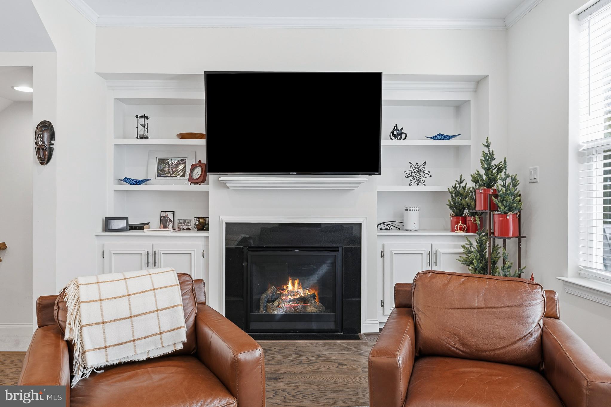 803 Francis Harris Place Annapolis, MD 21401 - Photo 18 of 52 a living room with furniture a flat screen tv and a fireplace