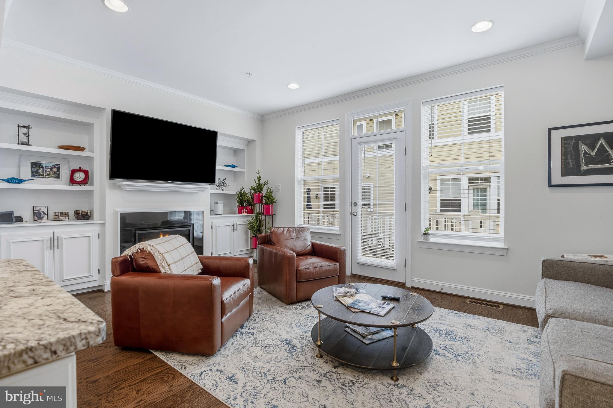 803 Francis Harris Place Annapolis, MD 21401 - Photo 19 of 52 a living room with furniture a flat screen tv and a fireplace