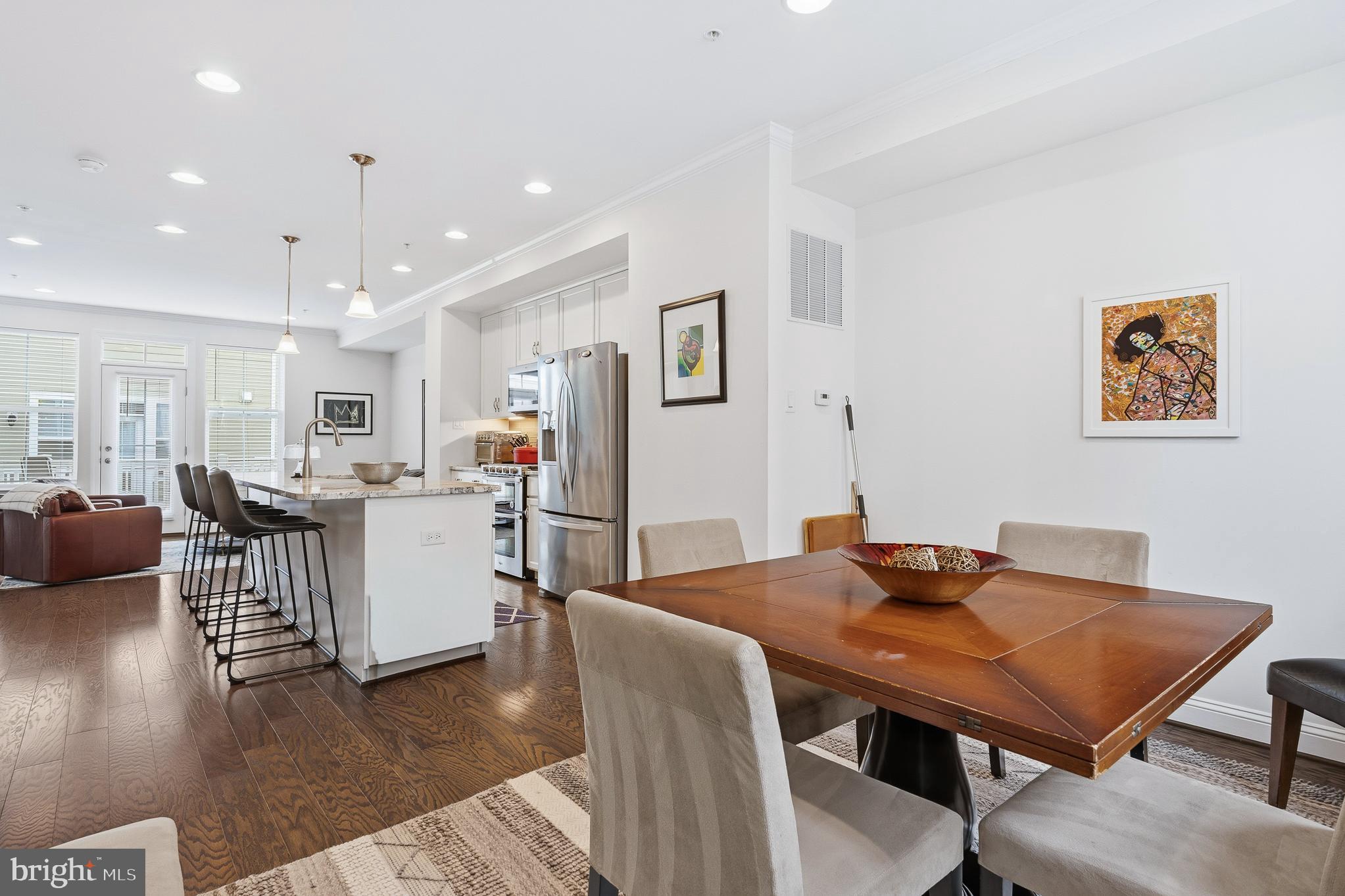 803 Francis Harris Place Annapolis, MD 21401 - Photo 23 of 52 a living room with furniture a table and kitchen view