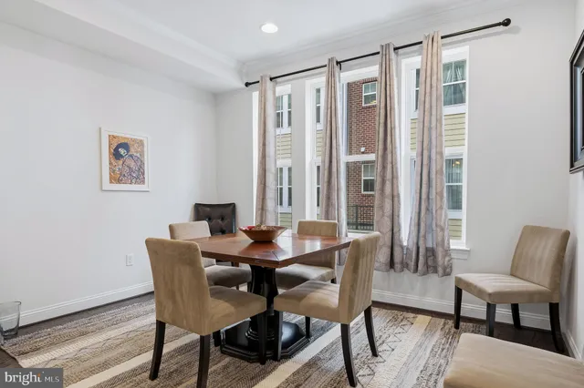 a living room with furniture a table and kitchen view
