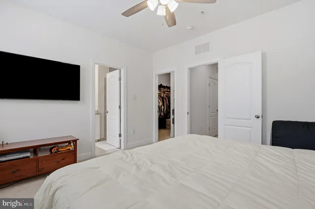 a bathroom with a granite countertop sink mirror and toilet