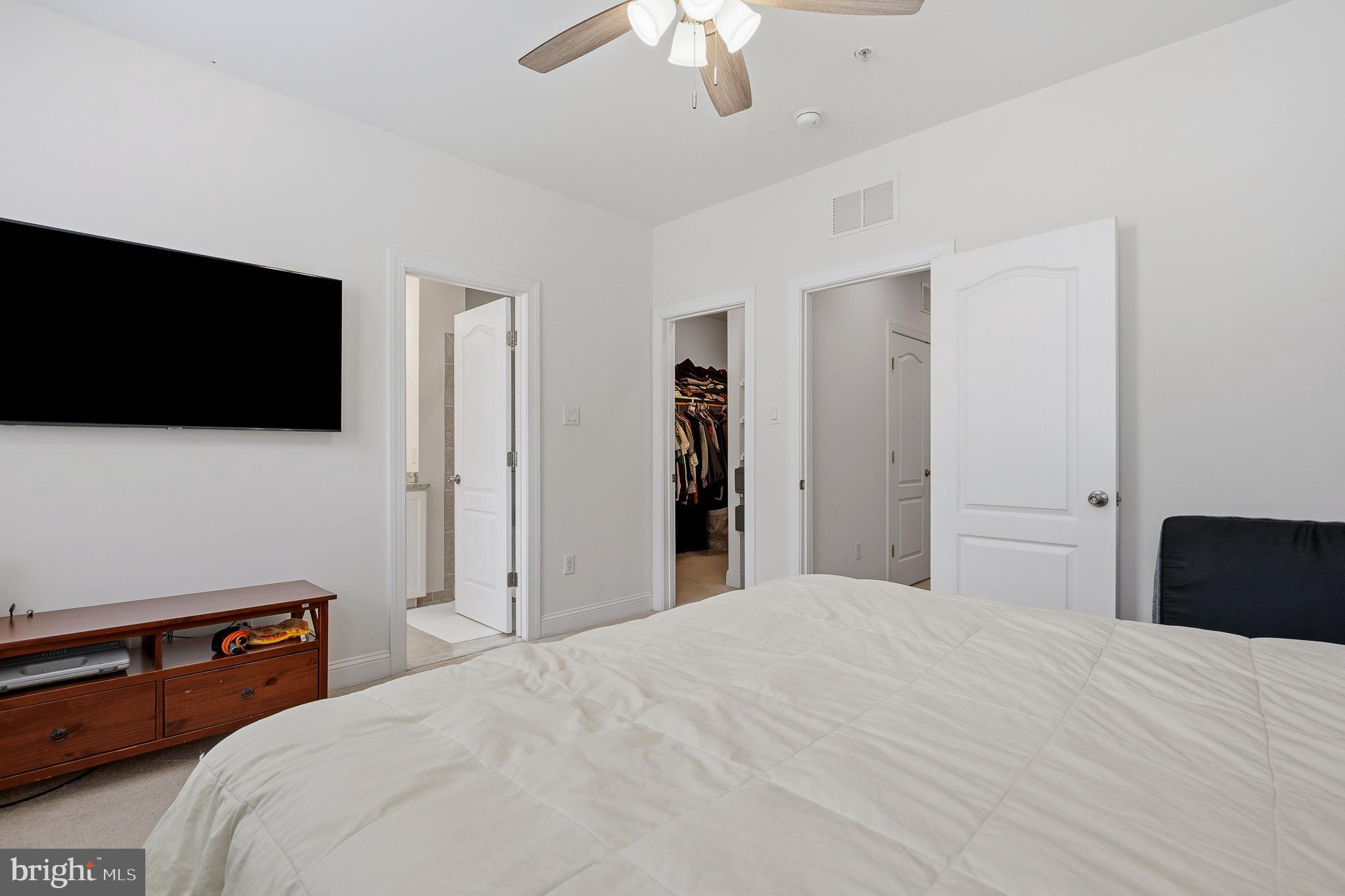 803 Francis Harris Place Annapolis, MD 21401 - Photo 29 of 52 a bedroom with a bed and a flat tv screen on wall