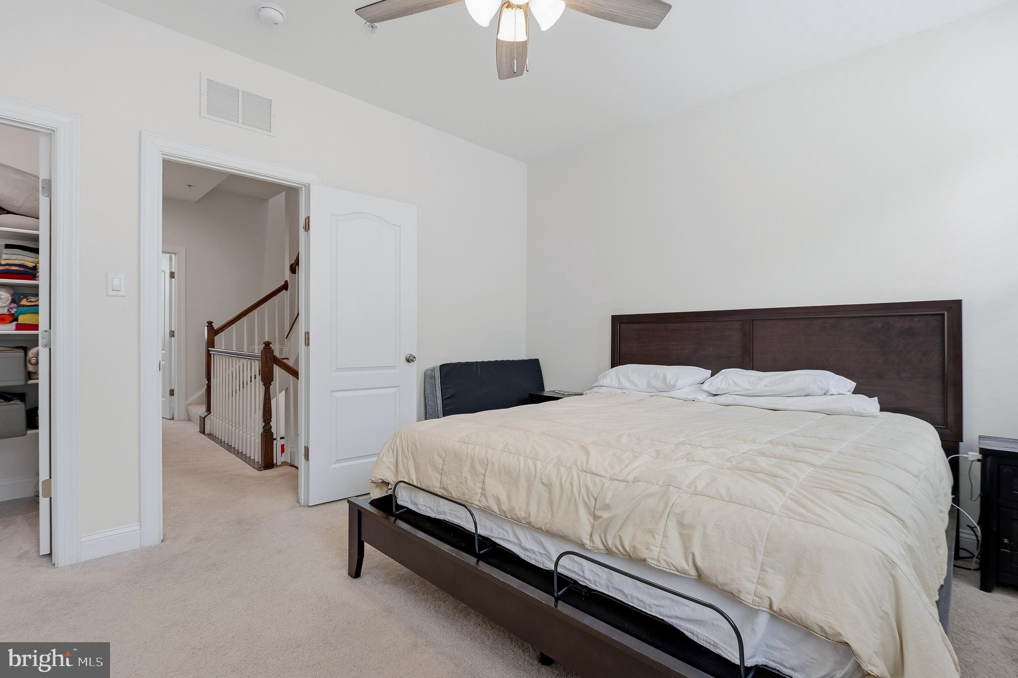 803 Francis Harris Place Annapolis, MD 21401 - Photo 30 of 52 a bedroom with a bed and a chandelier fan