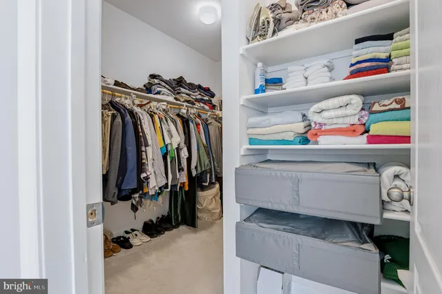 a bedroom with a bed and a chandelier fan