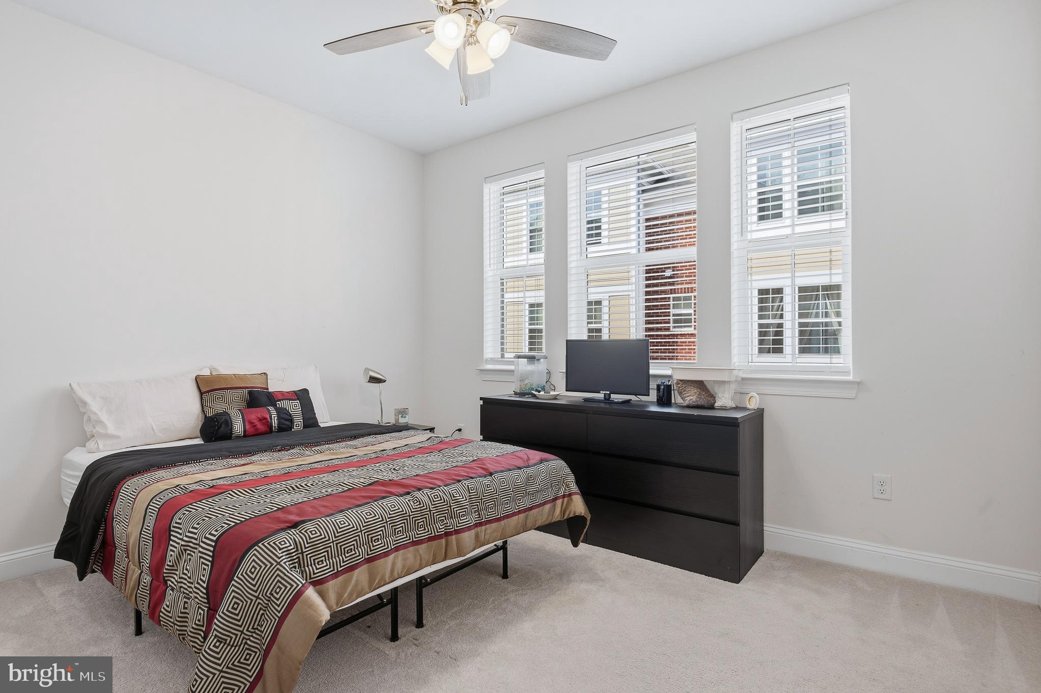 803 Francis Harris Place Annapolis, MD 21401 - Photo 33 of 52 a bedroom with a bed and a chandelier