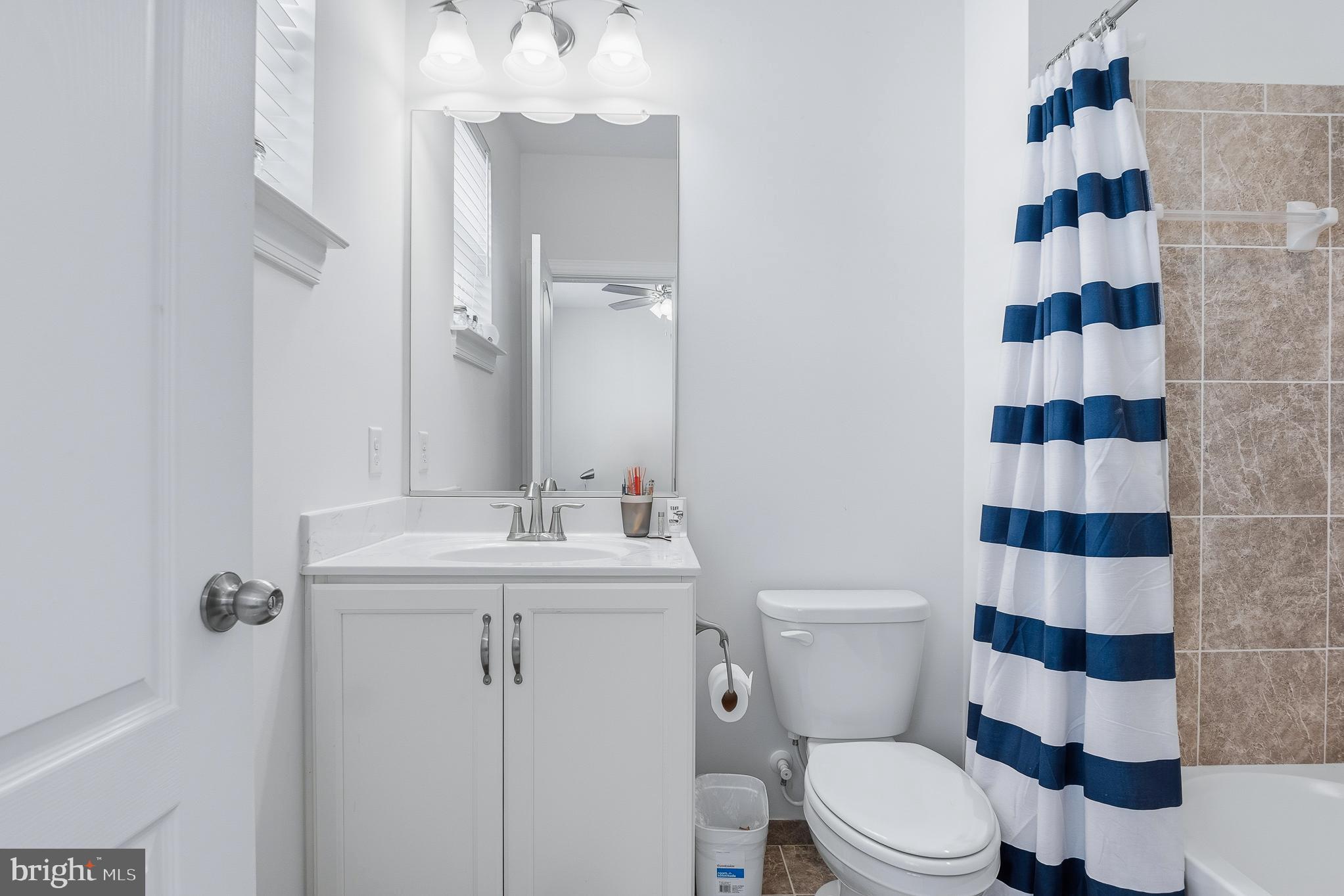 803 Francis Harris Place Annapolis, MD 21401 - Photo 37 of 52 a bathroom with a sink a toilet a mirror and shower