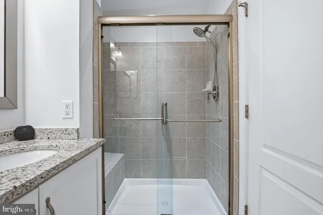 a bathroom with a sink a mirror and a shower