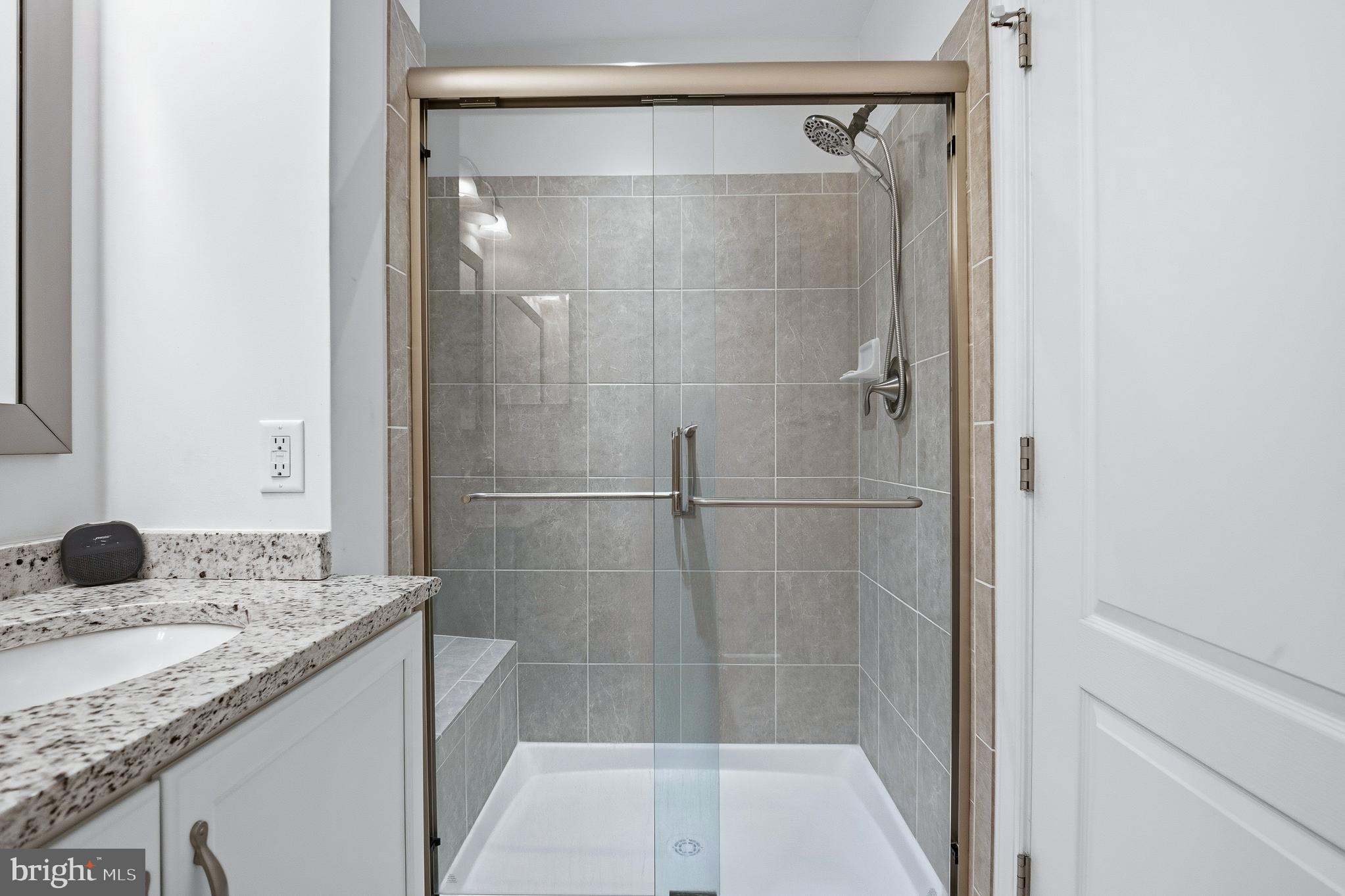803 Francis Harris Place Annapolis, MD 21401 - Photo 45 of 52 a bathroom with a granite countertop sink a toilet and shower