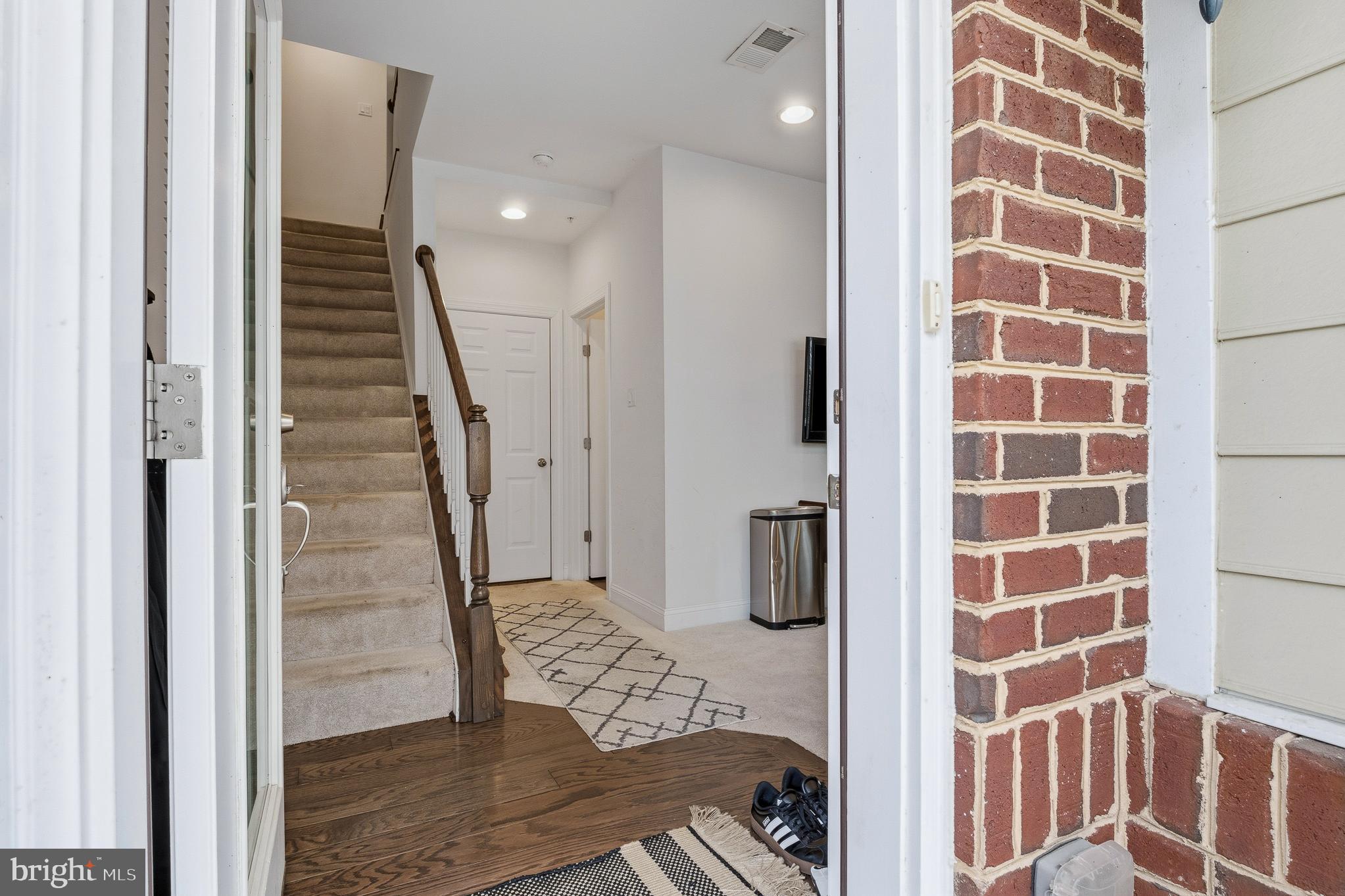 803 Francis Harris Place Annapolis, MD 21401 - Photo 6 of 52 a view of a hallway with wooden floor and a bathroom