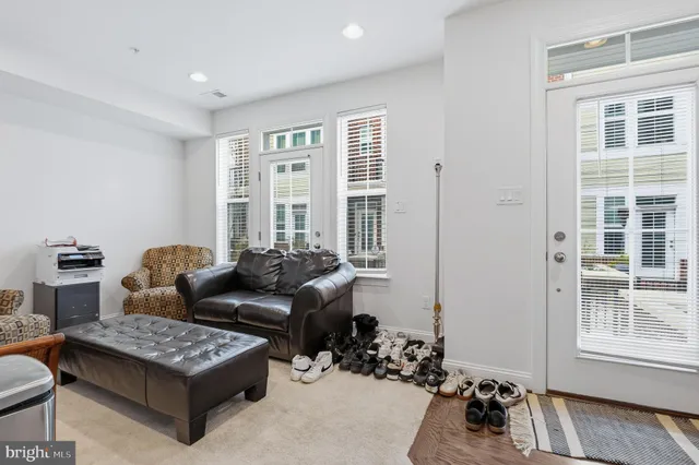 a living room with furniture lamp and window