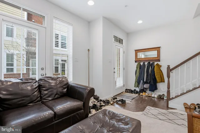 a living room with furniture a window and gym equipment