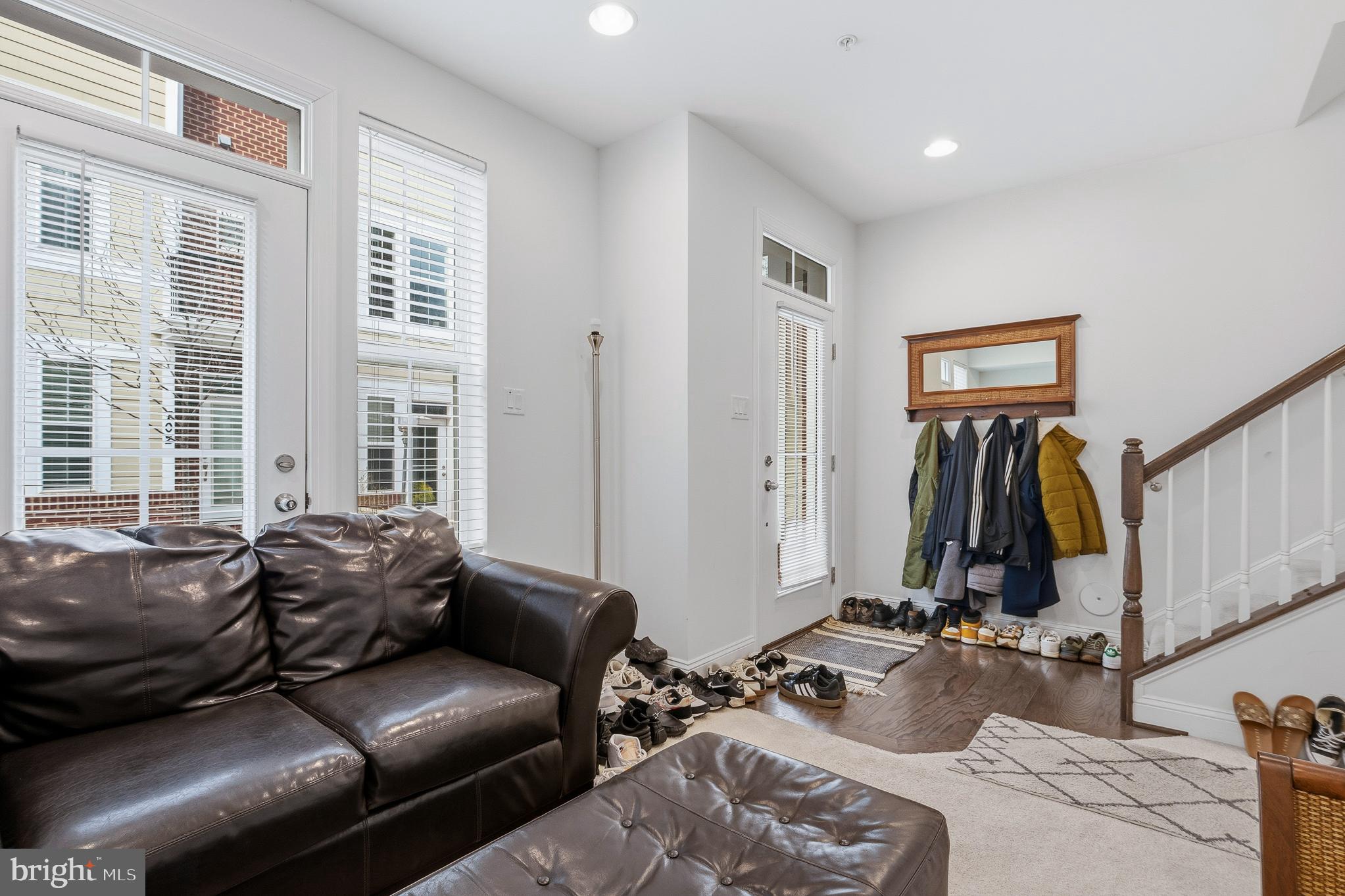 803 Francis Harris Place Annapolis, MD 21401 - Photo 9 of 52 a living room with furniture a window and gym equipment