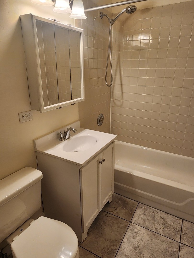 3219 West Division Street, Unit 2N Chicago, IL 60651 - Photo 11 of 14 a bathroom with a sink a toilet and shower