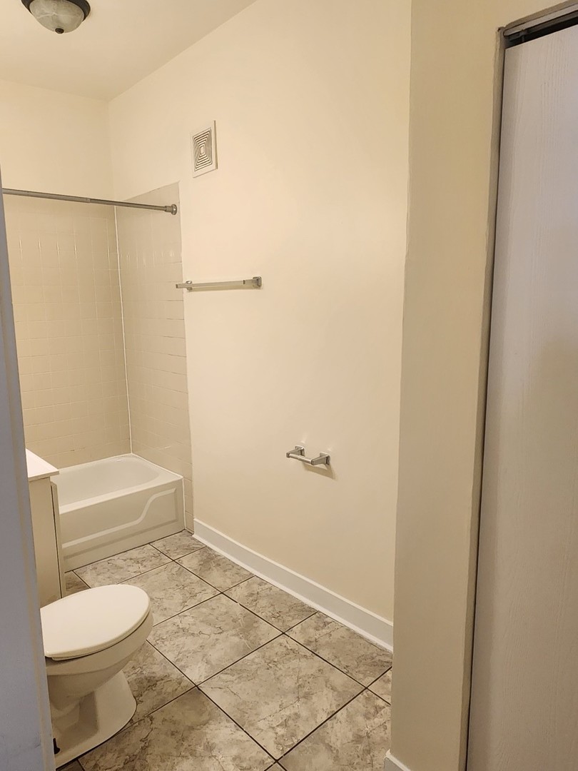 3219 West Division Street, Unit 2N Chicago, IL 60651 - Photo 12 of 14 a bathroom with a toilet and a shower